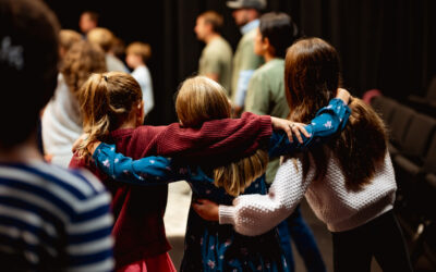 three girls with their arms around each other