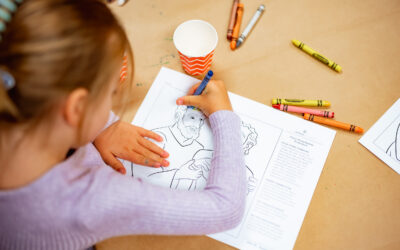 child coloring with crayons